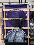 Hay Hoop display wooden stand with purple sheet behind it and extra hoops in bin below 